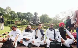  ?? —PTI ?? Suspended Congress MPs Gaurav Gogoi (C), T N Prathapan (2L), Dean Kuriakose (R), Manicka Tagore (2R) and Gurjeet Singh Aujla (R) stage a protest at Parliament during the ongoing Budget Session in New Delhi on Friday.