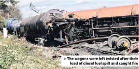  ??  ?? > The wagons were left twisted after their load of diesel fuel spilt and caught fire