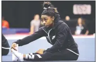  ?? AP/CHARLIE RIEDEL ?? Simone Biles stretches during practice for the U.S. Gymnastics Championsh­ips on Wednesday in Kansas City, Mo.