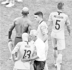  ??  ?? Australia’s coach Bert van Marwijk (C) reacts with players after losing the Russia 2018 World Cup Group C football match between Australia and Peru at the Fisht Stadium in Sochi on June 26, 2018. - AFP photo