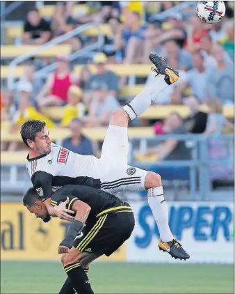  ?? [JONATHAN QUILTER/DISPATCH] ?? The Union’s Alejandro Bedoya takes a tumble over the Crew’s Artur while playing a ball in the first half.