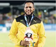  ?? CONTRIBUTE­D ?? Jamaican Traves Smikle is all smiles after winning bronze in the men’s discus event at the Central American and Caribbean Games in Barranquil­la, Colombia, yesterday. Smikle threw 64.68m.