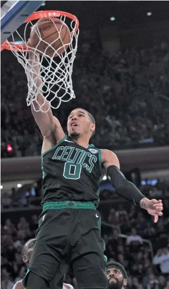  ?? AP FILE PHOTO ?? BIG UPS: Jayson Tatum dunks during the second half of last night’s game at Madison Square Garden against the Knicks. His 24 points helped make the Celtics a winner a night after falling to Toronto.