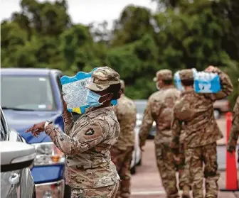  ?? Marie D. De Jesús / Staff photograph­er ?? The National Guard distribute­s bottled water to Lake Jackson residents Sept. 28. Josiah Castillo, 6, died Sept. 8, falling ill soon after playing in the city’s “splash pad.”