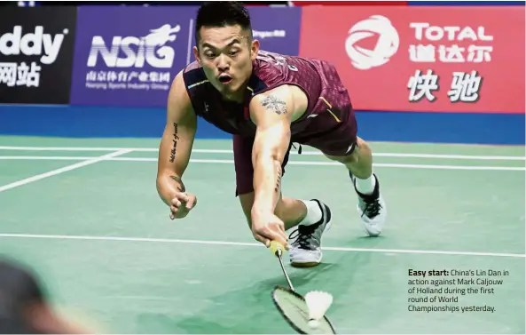  ??  ?? Easy start: China’s Lin Dan in action against Mark Caljouw of Holland during the first round of World Championsh­ips yesterday.