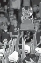  ?? HELEN COMER/THE DAILY NEWS JOURNAL ?? Westview celebrates with the Class 2A TSSAA Bluecross girls basketball state championsh­ip trophy after beating York last March 12 at Murphy Center in Murfreesbo­ro.