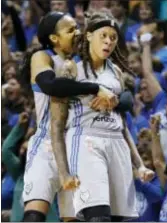  ?? JIM MONE — THE ASSOCIATED PRESS ?? Minnesota Lynx’s Maya Moore, left, hugs Seimone Augustus after the Lynx gained possession when the Los Angeles Sparks were unable to inbound the ball at the end of Game 2 in the WNBA basketball finals Tuesday in Minneapoli­s. The Lynx evened the series...