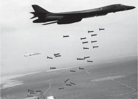  ?? U.S. Air Force ?? A B-1B Lancer drops cluster munitions in 2001. No matter your role, being part of a system meant to kill and destroy makes the mind grapple with a question: Where does culpabilit­y start, and where does it stop?
