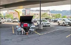  ?? Ben Braun/Post-Gazette ?? Brothers David and Danny Hess, of Blairsvill­e, have plenty of room to tailgate in a parking lot near PNC Park. As attendance drops, so does parking tax revenue collected by lot and garage operators on the North Shore.