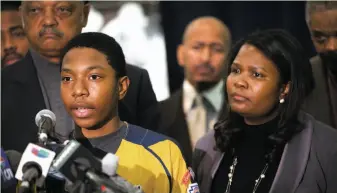  ?? Scott Olson / Getty Images ?? Brandon Green, a player for the Jackie Robinson West team, speaks alongside his mother, Venisa, after the team was stripped of its U.S. title. Behind him is Jesse Jackson.