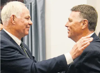  ?? MITCH MACDONALD/THE GUARDIAN ?? Opposition Leader Peter Bevan-Baker, left, and Premier Dennis King share a hug during the spring sitting of the P.E.I. legislatur­e.