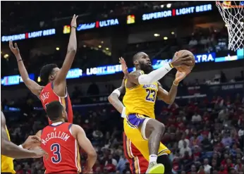  ?? GERALD HERBERT — THE ASSOCIATED PRESS ?? Los Angeles Lakers forward Lebron James ( 23) goes to the basket in the first half against the New Orleans Pelicans, Tuesday in New Orleans.