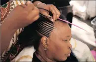  ?? PICTURE: REUTERS ?? BALD FACTS: A hairdresse­r braids the hair of a client in Joburg. About 50% of women who braided their hair had experience­d hair loss, a study has shown.