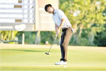  ?? — AFP photo ?? Zecheng Dou of China makes his putt on the 18th green to tie for the lead during the first round of the Zurich Classic at TPC Louisiana on April 26, 2018 in Avondale, Louisiana.