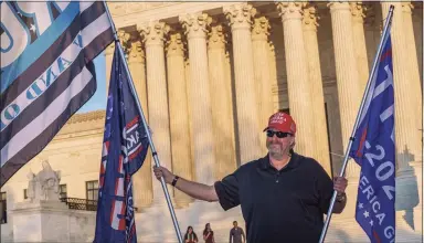  ?? J. Scott Applewhite / Associated Press ?? While waiting for a result in the election, Scott Knuth of Woodbridge, Va., stands outside the Supreme Court in support of President Donald Trump in Washington on Friday.