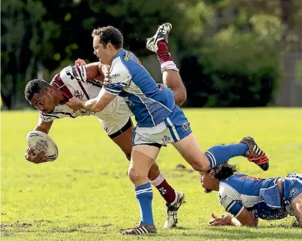  ??  ?? Papakura Sea Eagles’ centre King Vuniyayawa stumbles in the tacke of Glenora Bears’ halfback Aaron Booth.