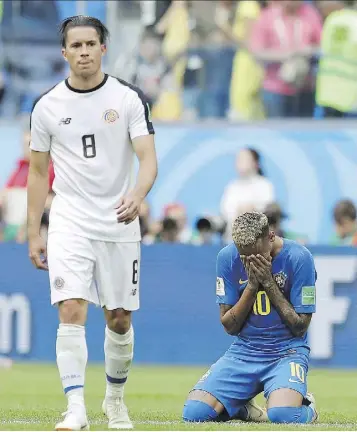  ?? THE ASSOCIATED PRESS ?? Neymar falls to his knees and appears to weep following Brazil’s 2-0 win over Costa Rica on Friday at the World Cup. His over-the-top displays of emotion are turning fans and officials against him.