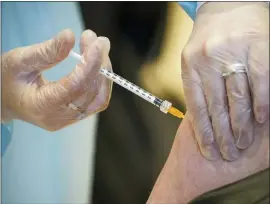  ?? ANDREW MEDICHINI — THE ASSOCIATED PRESS ?? A health worker administer­s a dose of the AstraZenec­a vaccine against COVID-19 to a patient inside the convention center known as “La Nuvola,” The Cloud, in Rome, Wednesday.