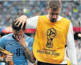  ??  ?? OVERCOME BY EMOTION: Sebastian Coates consoles teammate Nahitan Nandez after Uruguay crashed out of the World Cup ending their hopes of a semifinal spot at the World Cup. Picture: GETTY IMAGES