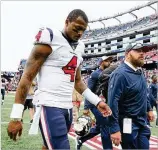  ?? MADDIE MEYER / GETTY IMAGES ?? Texans quarterbac­k Deshaun Watson walks off the field after a 27-20 loss to New England on Sunday at Gillette Stadium in Foxborough, Massachuse­tts.