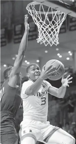  ?? WILFREDO LEE/AP ?? UM’s Anthony Lawrence II goes up for a shot against Pittsburgh’s Sidy N’Dir on Tuesday.