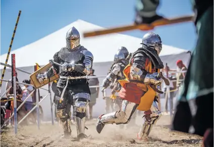  ?? PHOTOS BY GABRIELA CAMPOS/THE NEW MEXICAN ?? Fighters from the Albuquerqu­e Jackals and the Smoking Dragons face off in armored combat Saturday at the Santa Fe Renaissanc­e Faire at El Rancho De Las Golodrinas.