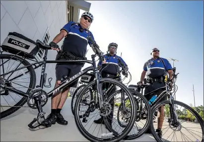  ?? Arkansas Democrat-Gazette/JOHN SYKES JR. ?? Little Rock bike patrol officer Kelley Crace (from left), Sgt. Van Watson and officer Marquise Goodlow prepare for a day on patrol.