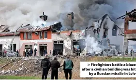  ?? ?? > Firefighte­rs battle a blaze after a civilian building was hit by a Russian missile in Lviv