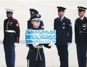  ?? IM HONG-JI/AFP/GETTY IMAGES ?? The remains of U.S. servicemen killed in the Korean War arrive in South Korea from North Korea on Friday, the 65th anniversar­y of the armistice that ended fighting. Forensic scientists in the U.S. will attempt to identify the remains.