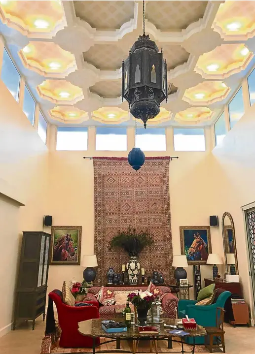  ?? —PHOTOS BY LYN RILLON ?? Cathedral ceiling with glass windows around it lets the natural light in, making the room airy, even cozy. At left, Renato and Tokie Enriquez with Nemo the Yorkie, the third member of their family.