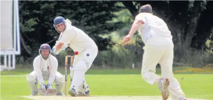  ??  ?? Menai Bridge batsman Robbie Jones up against Bangor bowler Andy Williams