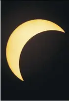  ?? PHOTOS: DAVID BLOOM ?? Daniel Fry, 12, and his grandmothe­r Hilda Vazquez watch the partial eclipse during a viewing party hosted by the Telus World of Science and members of the Royal Astronomic­al Society of Canada.