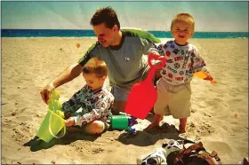  ?? ?? Darren Goad plays on the beach with his sons Joshua and Jacob when they were toddlers. They were diagnosed with autism right around the time of this photo. Now they are 24 and 25-years-old and live in a residentia­l community near their parents.