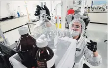  ?? SEAN KILPATRICK THE CANADIAN PRESS ?? Lab technician Christina Navarro works at Canopy Growth Corp's Tweed facility in Smiths Falls. As a holder of a dealers licence, Tweed is able to perform marijuana research, developmen­t and testing.