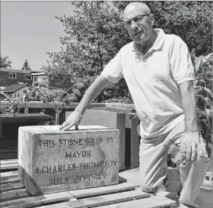  ?? JEREMY FRASER/CAPE BRETON POST ?? Chuck Thompson kneels down beside a stone in honour of his grandfathe­r A. Charles Thompson, a former mayor of the Town of North Sydney. The stone was part of the former Thompson School in North Sydney and was laid during the constructi­on process on July 20, 1949. It was removed prior to the demolition of the school this month.