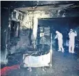  ??  ?? Investigat­ors inside the hospital in Piatra Neamt, after a fire that killed 10 patients