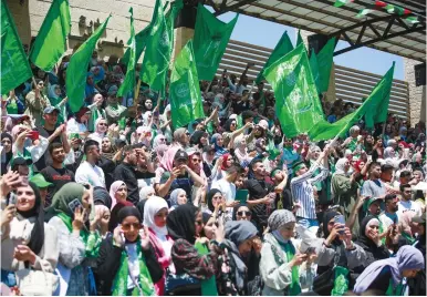  ?? (Flash90) ?? PALESTINIA­N STUDENTS wave Hamas flags during a rally at Birzeit University, near Ramallah, last week.