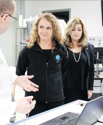  ?? STEPHANIE BABYCH ?? During a short Calgary tour, Gov. Gen. Julie Payette visited the University of Calgary’s NeuroArm lab with Dr. Garnette Sutherland. Payette also tested a robot arm used in surgeries.