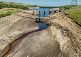  ?? Photograph: Danny Lawson/ PA ?? Baitings reservoir in Ripponden, West Yorkshire, in summer 2022, when the total stock of water in England's reservoirs was at its lowest level since 1995.