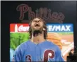  ?? CHRIS SZAGOLA — THE ASSOCIATED PRESS ?? Philadelph­ia Phillies’ Bryce Harper celebrates the team’s win over the Chicago Cubs in a baseball game Thursday.