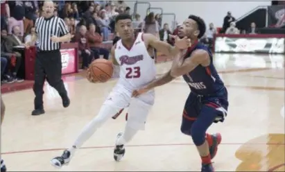  ?? JOHN BLAINE — FOR THE TRENTONIAN ?? Rider’s Stevie Jordan, left, drives past Robert Morris’ Jon Williams, right, during Saturday afternoon’s game.