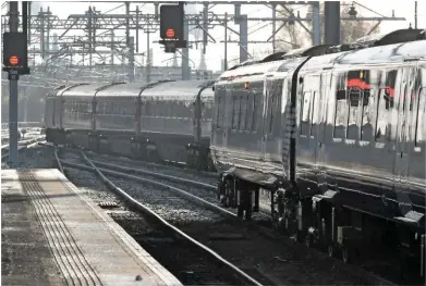  ?? PHILIP HAIGH. ?? A Class 385 waits to leave Stirling on December 10 2018, as a ‘classic’ High Speed Train arrives. ScotRail has been told to improve its performanc­e by the Scottish Government, following an increase in the number of cancelled services.