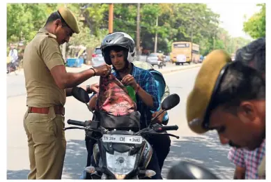  ??  ?? Spot check: A member of an election commission ‘flying squad’ searching a motorbike rider in the south Indian city of Coimbatore in Tamil Nadu state. — AFP