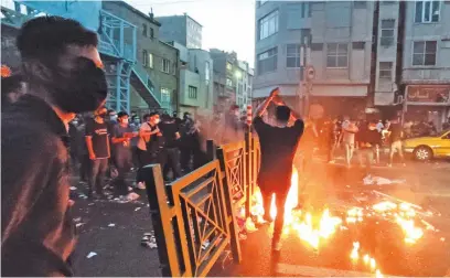  ?? Picture: AFP ?? ENOUGH. Iranian demonstrat­ors taking to the streets of the capital Tehran during a protest for Mahsa Amini, days after she died in police custody. Protests spread to 15 cities across Iran overnight over the death of the young woman.