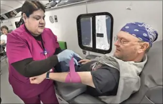  ?? Dan Watson/ The Signal ?? Tracie Hamrick (left) and Robert Kowalczyuc (above) both donated blood in honor of Pedro Roman, who died in 2021 after a two-year battle with leukemia.