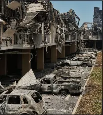  ?? PHILIP CHEUNG / THE NEW YORK TIMES ?? Buildings and vehicles are destroyed Aug. 11 in Lahaina, Hawaii. Wildfires that swept across parts of the island of Maui during the summer caused at least $5 billion in damage and left 99 people dead.