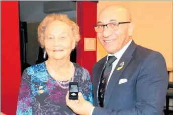  ?? PHOTO / CHRISTINE McKAY ?? Dannevirke and Districts RSA stalwart June Carr is presented with her merit badge for 50 years service by Ron Mark, Minister of Defence and Veterans’ Affairs at the Services and Citizens Club.