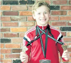  ?? COREY LEBLANC/SPECIAL TO POSTMEDIA NETWORK ?? Kieran Lupish is already at the highest level of competitio­n for his age. Here, he stands with his two gold medals he won earlier this month at the Ontario Cup in Kingston. At 13 years old, he's well on his way to achieve his dream of becoming a member...