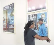  ?? ALIE SKOWRONSKI askowronsk­i@miamiheral­d.com ?? Carl-Philippe Juste measures a photograph selected for the ‘I Am Haiti’ exhibit on Thursday.