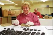  ?? SUBMITTED PHOTO — ST. MARK’S CHURCH ?? Volunteers at St. Mark’s Church in Conshohock­en create the church’s signature Easter egg candies. The church has been making the holiday treats for 100 years.